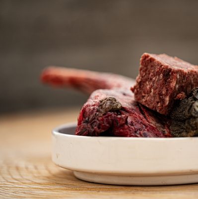 Assortment Of Ingredients Including,Wallaby Shoulder And Cubed Wallaby Mixed Meat In Ceramic Dog Bowl