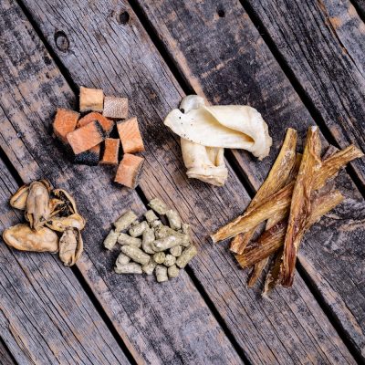 Assortment Of Raw Essentials Treats Including, Salmon, Mussels, Tripe, Lamb Ear, And Venison Tendon